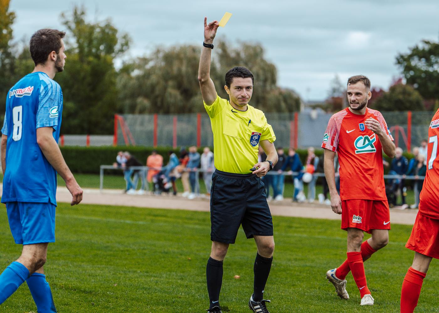 A referee signalling during a match